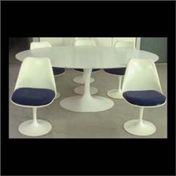 Eero Saarinen dining chairs, a set of six manufactured by Knoll.  White fiberglass seat and back on