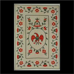 Quilt with American Eagle in center, surrounded by stylized tulips  and daisies. Colors are red, gre