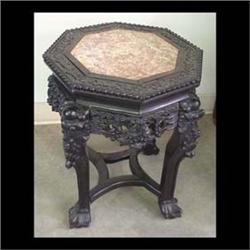 Carved Oriental plant stand; octagon top has pink marble  inset. 19"h x 14"d $150-200