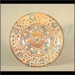 Tin-glazed charger, Spanish. Circa 1500-1700. Extensive restoration  to charger. 13" d $200-300