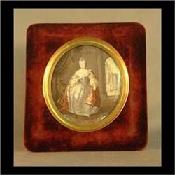 Oval painting on ivory. Woman in court attire. Mounted in beveled  glass with a brass and velvet fra