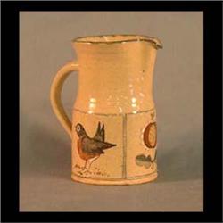 Contemporary Russell Henry Pottery pitcher. Decorated with robins  and stylized flower. Written on t