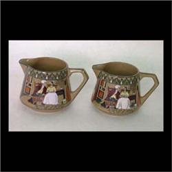 Pair of Buffalo Pottery Emerald Deldare creamers. Dr. Syntax with  the dairy maid. One artist signed
