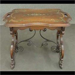 Carved walnut tea table. Scalloped top has a hand-painted floral  and scroll design. Cut-out legs en