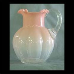 Victorian art glass pitcher. Pink shading to clear with reeded  handle and crimped top. Note some st