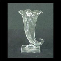 Steuben clear glass cornucopia shaped vase on a square plinth.  Signed Steuben. 6 1/2" h X 4" d $120