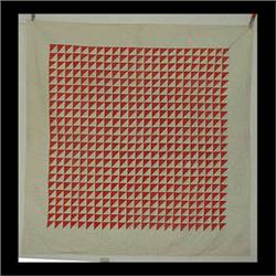 White and red quilt. Names written in the white spaces. Written in  one corner is "First brick laid