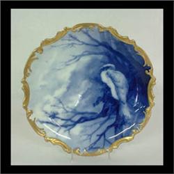 Limoges charger. Blue and white decoration of a bird perched in a  tree. Gilt border. Marked L.S. &
