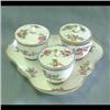 Sevres condiment set with lids. Floral decorations throughout. Jars  set on a triangular shaped scal
