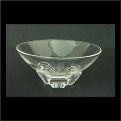 Clear glass bowl, attributed to Steuben. The bowl has a free form,  asymmetrical rim, and sits on a