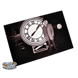 Photograph of Christopher Lloyd as "Doc Brown" in front of the clock from Back to the Future III