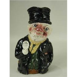 An unusual pottery Toby jug bearing a labe...