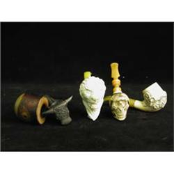 Three meerschaum pipes in the form of a sk...