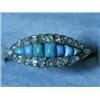 A yellow metal ring set with turquoise and...
