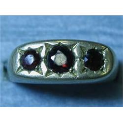 A 9ct gold three stone garnet ring, size W...