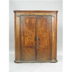 A George II walnut two door corner cupboar...