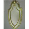 Image 1 : A gilt shield shaped wall mirror. 99cm hig...