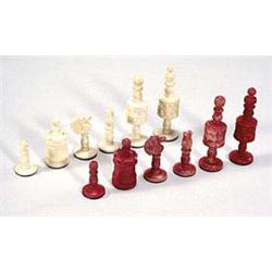 A bone chess set of turned form with serra...