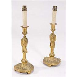 A pair of French gilt metal candlesticks,...