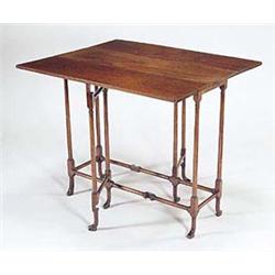 A mahogany rectangular spider leg table in...