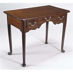 A mahogany side table in George II style,...