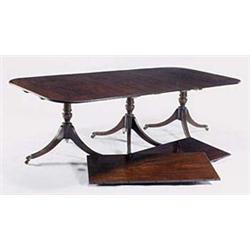 A mahogany three pillar dining table in Re...