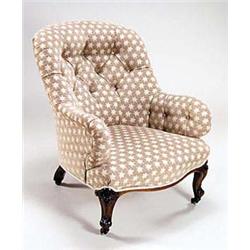A Victorian walnut armchair with a padded...