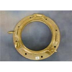 A circular brass port hole 19"...