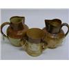 Image 1 : A Royal Doulton stoneware three-handled mug,