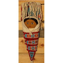 Doll in heavily beaded cradleboard