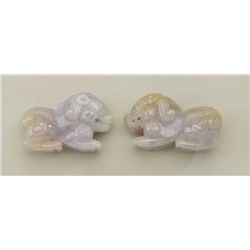 One pair of beautifully carved matching Fu  dogs in lavender jade. Est. $250-$300