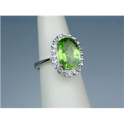 Spectacular 14 karat white gold ladies  designer ring set with a fine checkerboard  cut green perido