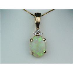 Elegant 14 karat yellow gold ladies  enhancer/pendant set with an oval Australian  opal weighing app