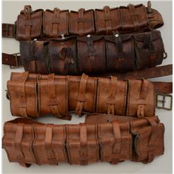 Lot of four leather and canvas European  military cartridge belts, each with five  attached cartridg