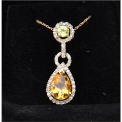 Beautiful pendant in 10k yellow gold set with  a pear shaped citrine diamonds and a  peridot. Est. $