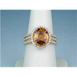 Exquisite 14 karat yellow gold contemporary  ring set with a fine oval orange sapphire  weighing app