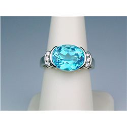 Stylish 14 karat white gold ladies ring fine  set with an oval Swiss blue topaz weighing  approx. 6.