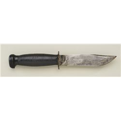 U.S. military knife by Camillus of New York  marked “U.S.N.” on the hilt with stacked  leather disc 