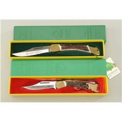 Lot of two Puma brand hand-made folding  knives in factory plastic cases with stag  grips and both i