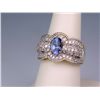 Image 2 : Sensational 14 karat two-tone gold ladies  ring set with a center oval Tanzanite  weighing approx. 1