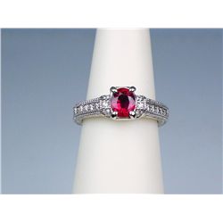 Elegant 14 karat white gold ladies vintage  design ring set with a center blood red ruby  weighing a