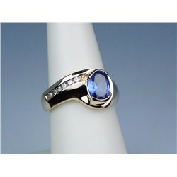 Stylish 14 karat yellow gold freeform custom  made ring set with an oval Tanzanite weighing  over 1.