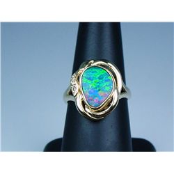 Fabulous 14 karat yellow gold ladies ring  bezel set with an Australian opal of fine  colors of blue