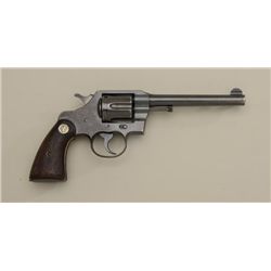 Colt Official Police DA revolver, .38 cal.,  6” barrel, blue finish, checkered wood  medallion grips