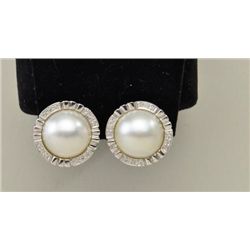 One 14k white gold ear studs set with Mabe  pearls and .25ct diamonds. The studs are  furnished with