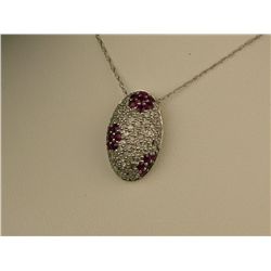 Charming 10 karat white gold ladies pendant  pave set with over 70 round diamonds and  rubies weighi