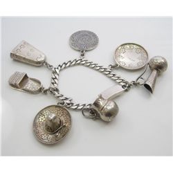 Splendid Sterling silver ladies multi charm  bracelet weighing over 64 grams. Estimate  $400-$600 Ni