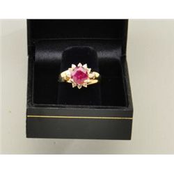 One 14k yellow gold ladies ring set with a  round ruby weighing 2.25ct surrounded by 12  diamonds (r