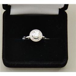 One ladies diamond ring set in 14k white gold  set with a round brilliant diamond weighing  approxim