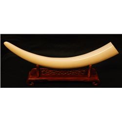 CHINESE IVORY TUSK ON WOODEN STAND
